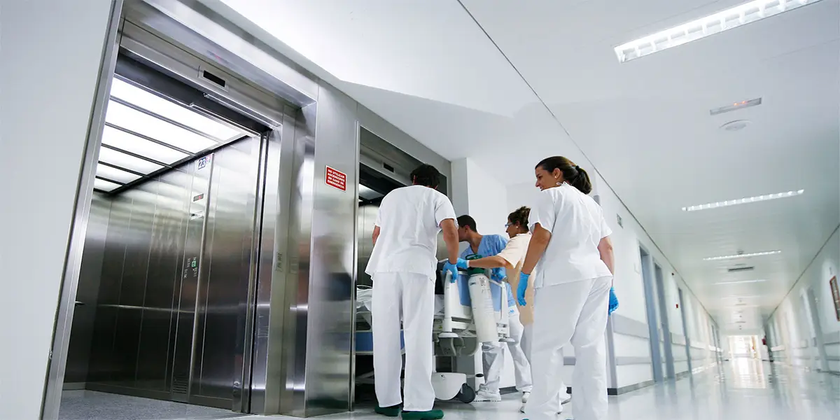 Hospital elevator with stretcher capacity and hygiene features