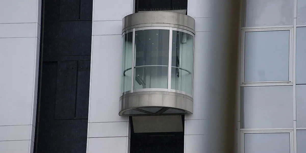 Panoramic glass elevator in an atrium in the UAE